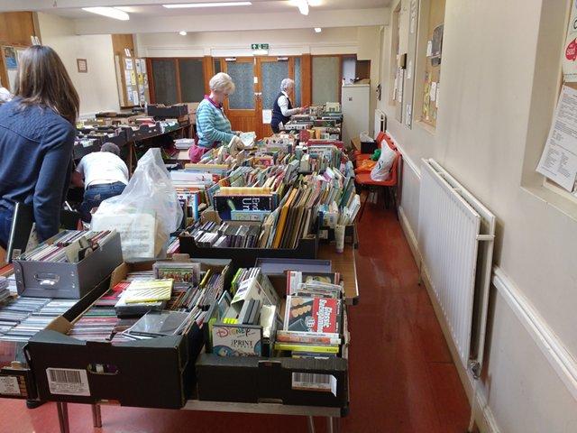 A room full (nearly) of books, with records, tapes and CDs at the near end